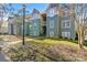 Green two-story townhouses with white-trimmed windows and landscaping at 20105 Henderson Rd # J, Cornelius, NC 28031