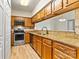 A bright kitchen featuring stainless steel appliances, ample wood cabinetry, and granite countertops at 20105 Henderson Rd # J, Cornelius, NC 28031