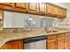 Kitchen with wood cabinets, granite countertops, stainless steel dishwasher, and a breakfast bar pass through at 20105 Henderson Rd # J, Cornelius, NC 28031