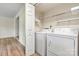 Laundry room with white washer and dryer and built-in shelving at 20105 Henderson Rd # J, Cornelius, NC 28031