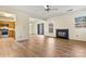 Open living area with fireplace and updated wood-look flooring and kitchen access at 20105 Henderson Rd # J, Cornelius, NC 28031