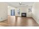 Living room with fireplace, ceiling fan, sliding glass door, and wood-look floors at 20105 Henderson Rd # J, Cornelius, NC 28031
