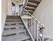 Carpeted stairway with metal railing leading to the condo entrance at 20105 Henderson Rd # J, Cornelius, NC 28031