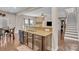 Eat-in kitchen with island, breakfast bar, granite countertops, and view of living area at 2323 Barrowcliffe Nw Dr, Concord, NC 28027