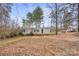 Front exterior view of a single-story home with a driveway and surrounding trees at 2511 Swanson Rd, Crouse, NC 28033