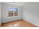 Bright bedroom with hardwood floors and two large windows at 3026 Hawick Commons Dr, Concord, NC 28027