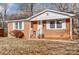 Front view of a brick ranch home with white shutters at 3112 Cedarhurst Dr, Charlotte, NC 28269