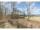 View of the backyard with mature trees and a partially wooded area at 326 Chestnut Ridge Rd, Kings Mountain, NC 28086