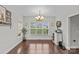 Bright dining room with hardwood floors, large window, and built-in shelving at 4004 Camden Oaks Ln, Monroe, NC 28110