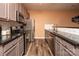 Modern kitchen with gray cabinets and stainless steel appliances at 7741 Abigail Glen Dr, Charlotte, NC 28212