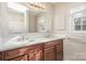 Dual vanity bathroom with brown wood cabinets and white countertops at 8039 Tifton Rd, Charlotte, NC 28226