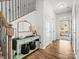 Bright foyer with wood floors, staircase, and stylish decor at 8306 Hibiscus Ln, Fort Mill, SC 29707