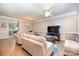 Living room with hardwood floors, sectional sofa, and kitchen view at 9533 Brackenview Ct, Charlotte, NC 28214