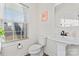 Clean and modern bathroom with pedestal sink and window at 1051 Barnette Farm Ln, Monroe, NC 28110