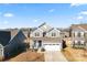 Two-story house front with gray siding, two car garage, and porch at 1051 Barnette Farm Ln, Monroe, NC 28110