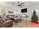 Relaxing living room featuring brown leather furniture and a Christmas tree at 1051 Barnette Farm Ln, Monroe, NC 28110