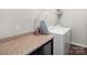 Laundry room with washer, dryer, and folding counter at 117 Fairfield Dr, Troutman, NC 28166