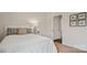 Bright bedroom with white bedding and an ensuite bathroom at 12157 Lady Bell Dr, Charlotte, NC 28278