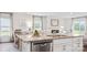 Modern kitchen with white cabinets, granite countertops, and an island with sink and dishwasher at 12157 Lady Bell Dr, Charlotte, NC 28278