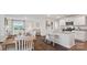 Open-concept kitchen and dining area with white cabinets, granite countertops, and stainless steel appliances at 12157 Lady Bell Dr, Charlotte, NC 28278