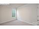 Empty bedroom with neutral-colored walls, carpeting, and a single window at 2035 Skyhawk Dr, York, SC 29745