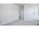Empty bedroom with neutral-colored walls, carpeting, and a closed door at 2035 Skyhawk Dr, York, SC 29745