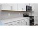 Bright, modern kitchen featuring white shaker cabinets, herringbone backsplash, and stainless steel appliances at 2035 Skyhawk Dr, York, SC 29745