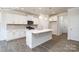 Modern white kitchen with island, stainless steel appliances, and wood-look flooring at 2035 Skyhawk Dr, York, SC 29745