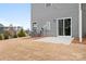 Gray townhome with sliding glass door and small patio area at 2795 Yeager Nw Dr, Concord, NC 28027