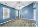 Bright bedroom with blue walls, wood-look floors, and two large windows at 2916 Waycross Dr, Monroe, NC 28110