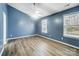 Spacious bedroom with light wood flooring and blue walls at 2916 Waycross Dr, Monroe, NC 28110