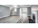 Living room with wood-look flooring, fireplace, ceiling fan, and open layout at 2916 Waycross Dr, Monroe, NC 28110