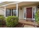 Inviting front entrance with a red door and white columns at 9154 Snow Hill Ct, Charlotte, NC 28269