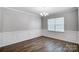 Bright dining room with wainscoting and wood-look flooring at 1025 Dali Blvd, Mount Holly, NC 28120