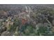 An aerial view showcasing the home's location within a residential neighborhood surrounded by trees at 121 Pam Dr, Gastonia, NC 28056