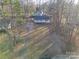 High-angle view of the home and property with surrounding trees and grassy lawn at 121 Pam Dr, Gastonia, NC 28056