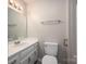 Simple bathroom with white vanity, toilet, and mirror at 121 Pam Dr, Gastonia, NC 28056