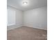 Vacant bedroom featuring neutral walls, carpeting, and window with blinds at 121 Pam Dr, Gastonia, NC 28056