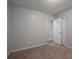 Empty bedroom with neutral walls, carpeting, and a door leading to another room at 121 Pam Dr, Gastonia, NC 28056