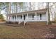 Inviting covered porch with white railing and brick accents on a one-story home at 121 Pam Dr, Gastonia, NC 28056