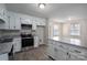 Updated kitchen with white cabinets, stainless steel appliances, and granite countertops at 121 Pam Dr, Gastonia, NC 28056
