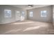 Spacious living room with carpet, ceiling fan, and several windows at 121 Pam Dr, Gastonia, NC 28056
