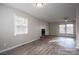 Fireplace and large windows in the living room with neutral walls and wood-look floors at 121 Pam Dr, Gastonia, NC 28056