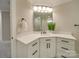 Corner vanity bathroom with white cabinets and quartz countertop at 1304 Pleasant Plains Rd, Matthews, NC 28105