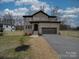 Brick two-story house with a two-car garage at 1304 Pleasant Plains Rd, Matthews, NC 28105