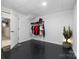 Finished basement closet with dark flooring and hanging rack at 1350 Kensington Cir, Newton, NC 28658