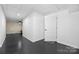 Finished basement hallway with dark flooring and access to other rooms at 1350 Kensington Cir, Newton, NC 28658