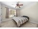 Bedroom with a striped comforter and ceiling fan at 1350 Kensington Cir, Newton, NC 28658