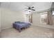 Basement bedroom with carpet, neutral decor, and two windows at 1350 Kensington Cir, Newton, NC 28658