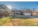 Brick ranch house with front porch, two-car garage, and landscaped yard at 1350 Kensington Cir, Newton, NC 28658